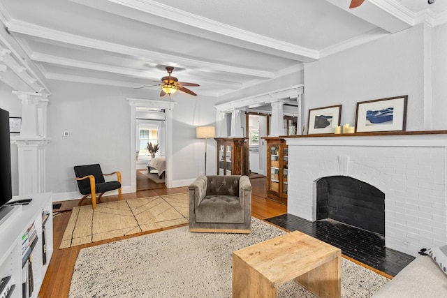 1600 S Adams St, Fort Worth, TX 76104 - living area with ceiling fan, healthy amount of natural light, ornate columns, beamed ceiling, and crown molding