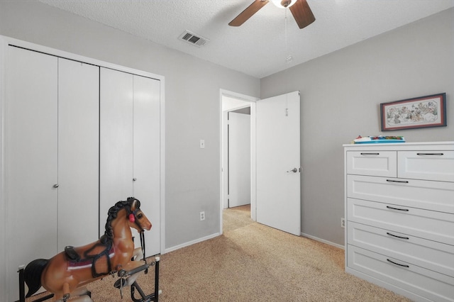 4109 Malone Ave, The Colony, TX 75056 - unfurnished bedroom featuring light carpet, a closet, a ceiling fan, and a textured ceiling