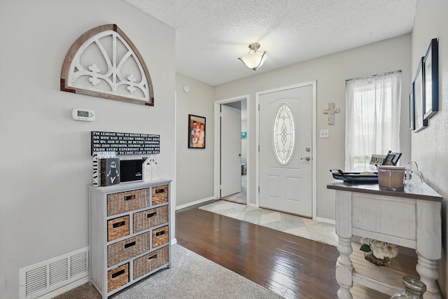 4109 Malone Ave, The Colony, TX 75056 - foyer with hardwood / wood-style flooring and a textured ceiling
