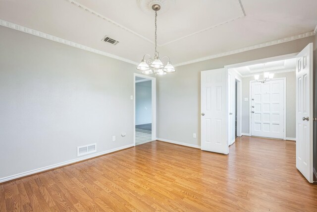 2413 Golden Willow Ln, Richardson, TX 75082 - spare room with light wood-type flooring, a chandelier, and crown molding