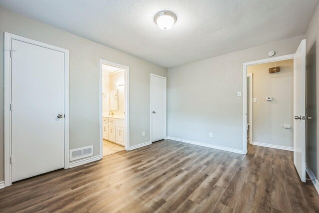 2413 Golden Willow Ln, Richardson, TX 75082 - unfurnished bedroom featuring wood finished floors and ensuite bathroom