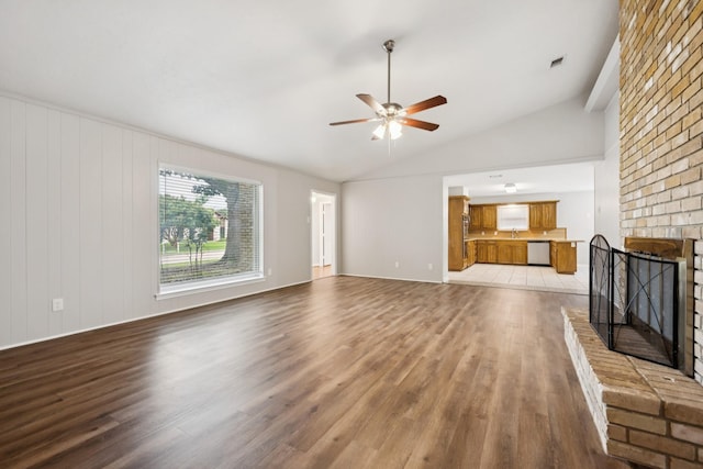 2413 Golden Willow Ln, Richardson, TX 75082 - unfurnished living room with light wood-style flooring, a ceiling fan, a fireplace, and vaulted ceiling