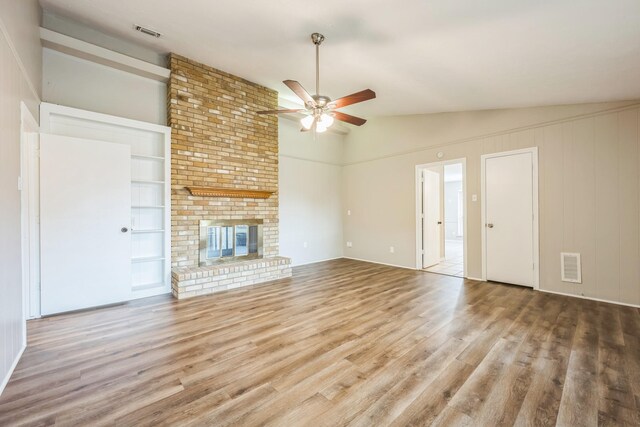 2413 Golden Willow Ln, Richardson, TX 75082 - unfurnished living room featuring vaulted ceiling, a ceiling fan, wood finished floors, built in features, and a fireplace