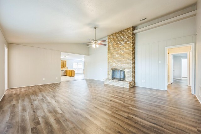 2413 Golden Willow Ln, Richardson, TX 75082 - unfurnished living room featuring ceiling fan, lofted ceiling, wood finished floors, and a fireplace