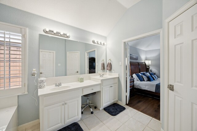 418 Long Cove Ct, Allen, TX 75002 - ensuite bathroom with vaulted ceiling, double vanity, and tile patterned floors