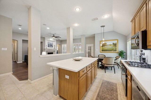 418 Long Cove Ct, Allen, TX 75002 - kitchen featuring stainless steel appliances, a fireplace, a ceiling fan, light countertops, and recessed lighting