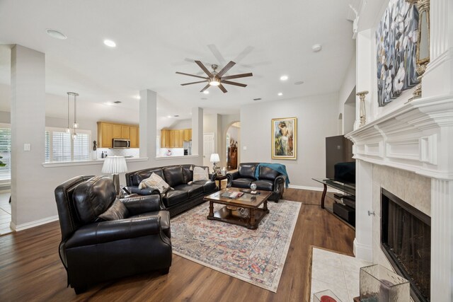 418 Long Cove Ct, Allen, TX 75002 - living area featuring a fireplace, a ceiling fan, arched walkways, dark wood-type flooring, and recessed lighting