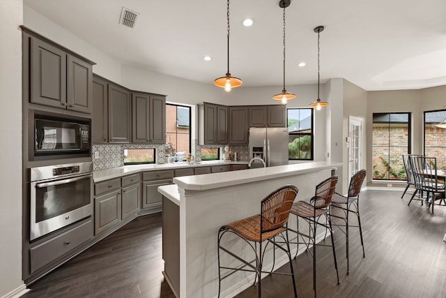 801 Cliffmoor Dr, Keller, TX 76248 - kitchen with appliances with stainless steel finishes, recessed lighting, light countertops, backsplash, and dark wood-style flooring
