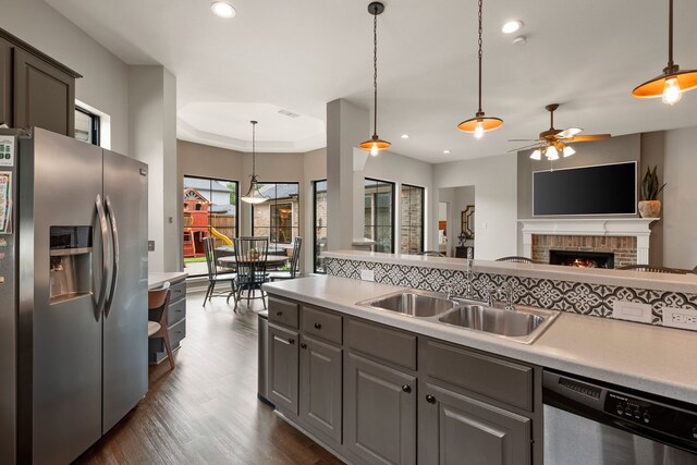 801 Cliffmoor Dr, Keller, TX 76248 - kitchen featuring appliances with stainless steel finishes, a ceiling fan, light countertops, gray cabinetry, and dark wood-style flooring