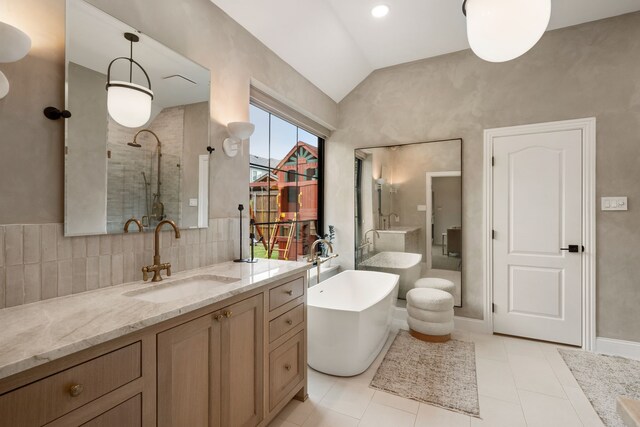 801 Cliffmoor Dr, Keller, TX 76248 - bathroom featuring lofted ceiling, vanity, tiled shower, a freestanding tub, and tile patterned floors