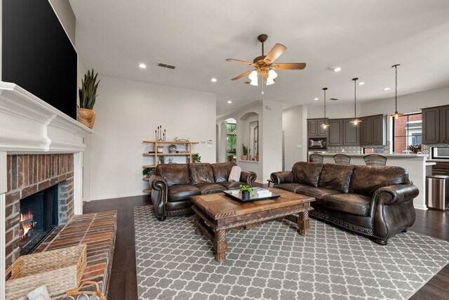 801 Cliffmoor Dr, Keller, TX 76248 - living area featuring ceiling fan, wood finished floors, a fireplace, recessed lighting, and arched walkways