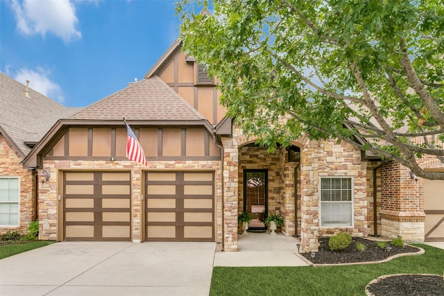 223 Wood St Unit 201, Grapevine, TX 76051 - tudor home with roof with shingles, concrete driveway, a garage, stucco siding, and stone siding