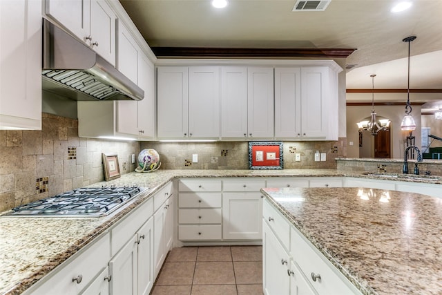 223 Wood St Unit 201, Grapevine, TX 76051 - kitchen with stainless steel gas cooktop, under cabinet range hood, decorative light fixtures, tasteful backsplash, and recessed lighting
