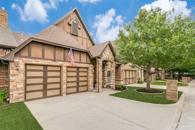 223 Wood St Unit 201, Grapevine, TX 76051 - tudor home featuring stucco siding, a shingled roof, driveway, an attached garage, and stone siding