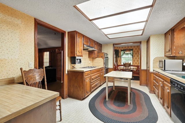 1419 Juniper Ln, Lewisville, TX 75077 - kitchen featuring wallpapered walls, black dishwasher, stainless steel microwave, under cabinet range hood, and stovetop