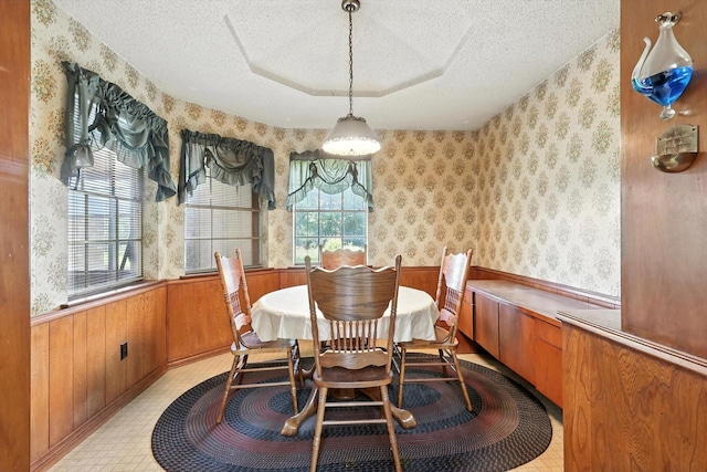 1419 Juniper Ln, Lewisville, TX 75077 - dining area with wallpapered walls, a textured ceiling, a wainscoted wall, and wooden walls