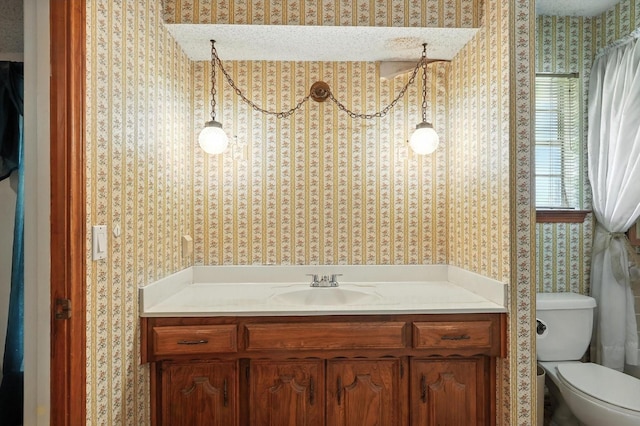 1419 Juniper Ln, Lewisville, TX 75077 - bathroom featuring wallpapered walls and vanity