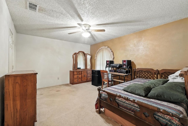 1419 Juniper Ln, Lewisville, TX 75077 - carpeted bedroom featuring a textured ceiling and ceiling fan