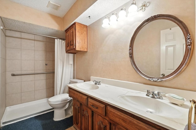 1419 Juniper Ln, Lewisville, TX 75077 - full bathroom with double vanity, a tile shower, and a textured ceiling