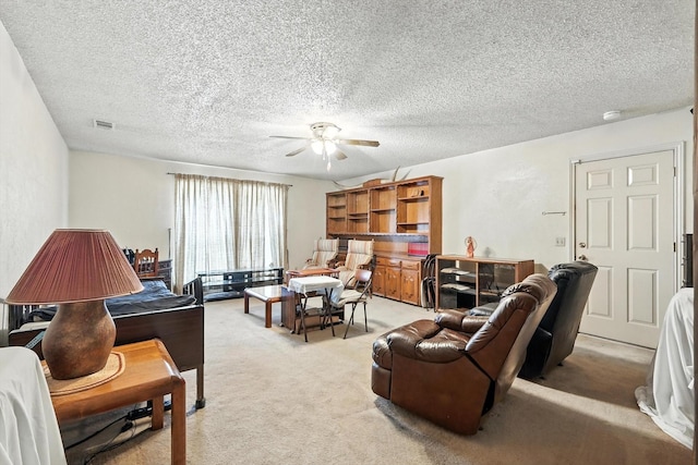 1419 Juniper Ln, Lewisville, TX 75077 - living room featuring a ceiling fan, light colored carpet, and a textured ceiling