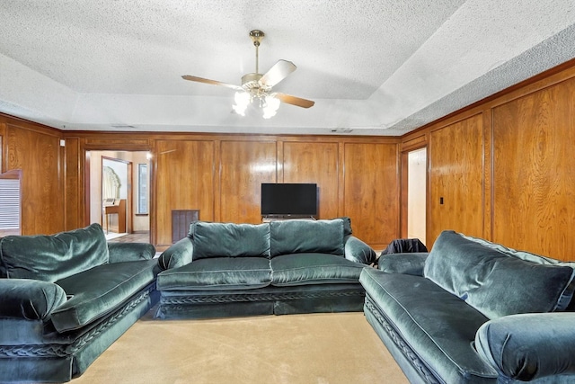 1419 Juniper Ln, Lewisville, TX 75077 - living area with carpet, a ceiling fan, a textured ceiling, lofted ceiling, and a tray ceiling