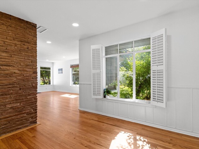 4608 Winthrop Ave E, Fort Worth, TX 76116 - spare room featuring wood finished floors, a decorative wall, a wainscoted wall, and recessed lighting