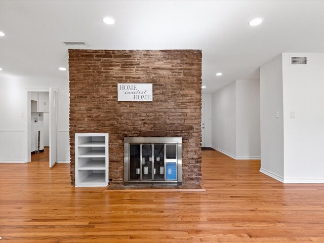 4608 Winthrop Ave E, Fort Worth, TX 76116 - unfurnished living room featuring wood finished floors, a glass covered fireplace, and recessed lighting