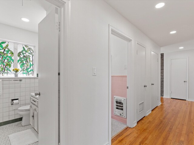4608 Winthrop Ave E, Fort Worth, TX 76116 - corridor with heating unit, tile walls, light wood-type flooring, and recessed lighting