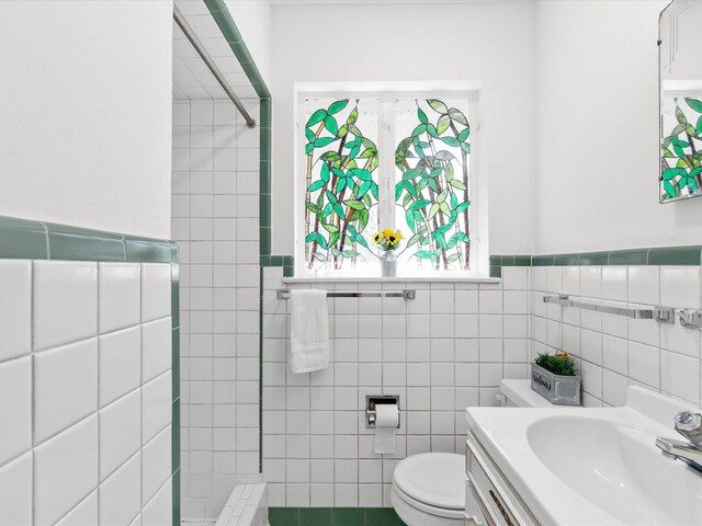 4608 Winthrop Ave E, Fort Worth, TX 76116 - full bathroom with tile walls, tiled shower, vanity, and wainscoting