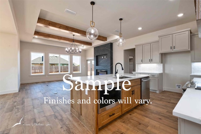 6602 Beals Creek Dr, Abilene, TX 79606 - kitchen featuring stainless steel dishwasher, backsplash, light countertops, wood finished floors, and beam ceiling