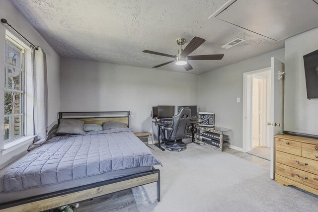 22 W Townhouse Ln Unit 34, Grand Prairie, TX 75052 - bedroom with attic access, a textured ceiling, carpet flooring, and a ceiling fan