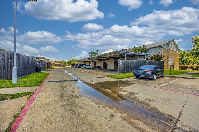 22 W Townhouse Ln Unit 34, Grand Prairie, TX 75052 - view of asphalt road featuring curbs