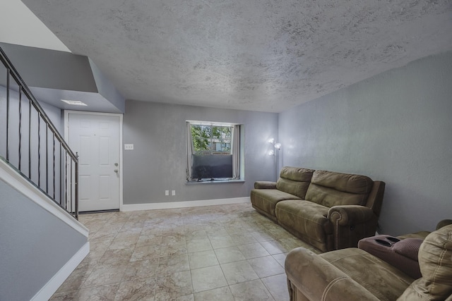22 W Townhouse Ln Unit 34, Grand Prairie, TX 75052 - living room with stairway and a textured ceiling