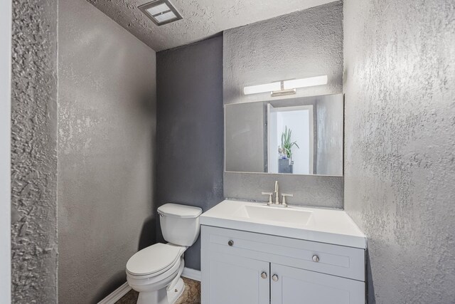 22 W Townhouse Ln Unit 34, Grand Prairie, TX 75052 - bathroom featuring vanity, a textured wall, and a textured ceiling