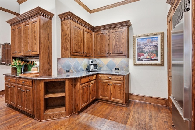17227 Lechlade Ln, Dallas, TX 75252 - kitchen featuring built in fridge, dark wood finished floors, ornamental molding, backsplash, and dark stone countertops