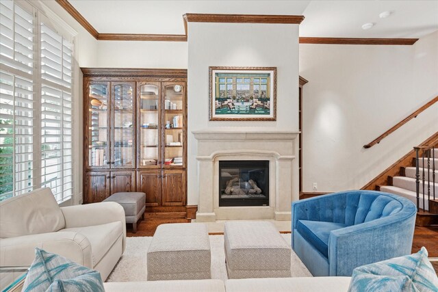 17227 Lechlade Ln, Dallas, TX 75252 - living room featuring crown molding, wood finished floors, stairway, and a glass covered fireplace