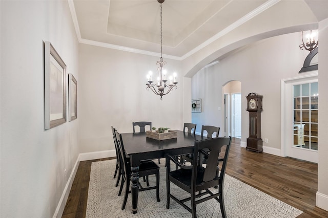 2413 Bachman Dr, Flower Mound, TX 75028 - dining space with dark wood-style floors, arched walkways, a chandelier, and crown molding