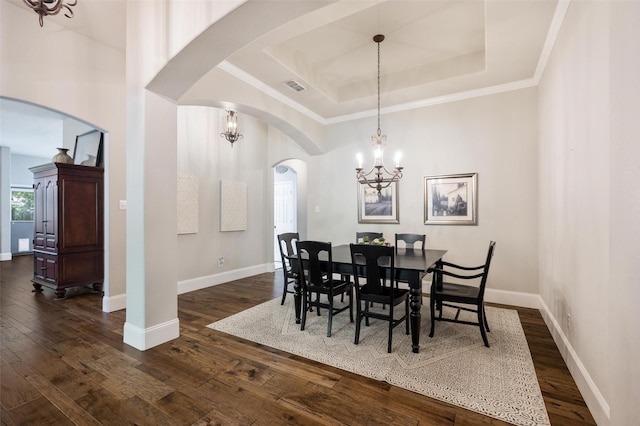 2413 Bachman Dr, Flower Mound, TX 75028 - dining room with arched walkways, a raised ceiling, a chandelier, dark wood finished floors, and ornamental molding
