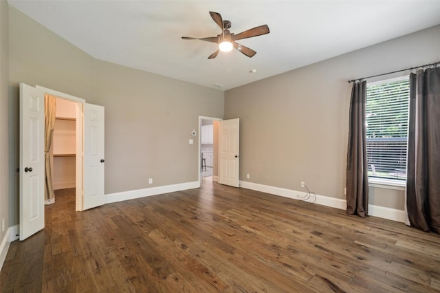 2413 Bachman Dr, Flower Mound, TX 75028 - unfurnished bedroom with dark wood-style flooring, a walk in closet, and a ceiling fan