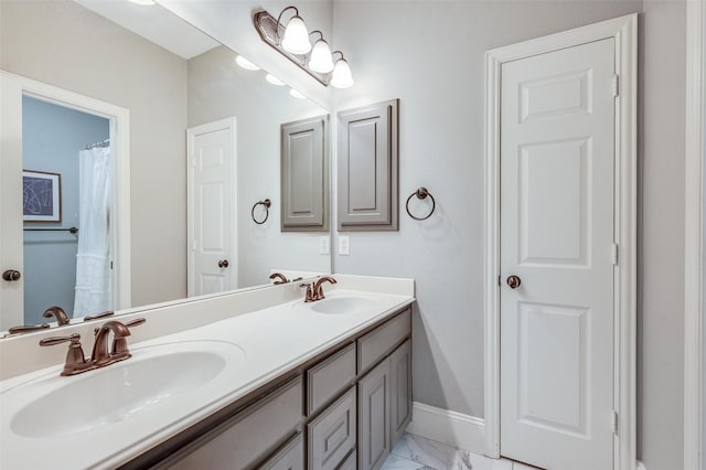 2413 Bachman Dr, Flower Mound, TX 75028 - bathroom with marble finish flooring and double vanity