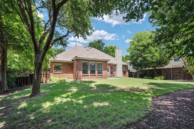 2413 Bachman Dr, Flower Mound, TX 75028 - rear view of house with brick siding, a fenced backyard, a chimney, and roof with shingles