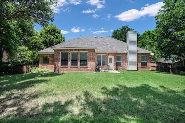 2413 Bachman Dr, Flower Mound, TX 75028 - back of property with brick siding, a fenced backyard, and a shingled roof