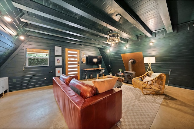 120 Lakeway Ln, Gun Barrel City, TX 75156 - living room featuring a wood stove, concrete flooring, beam ceiling, and wooden walls