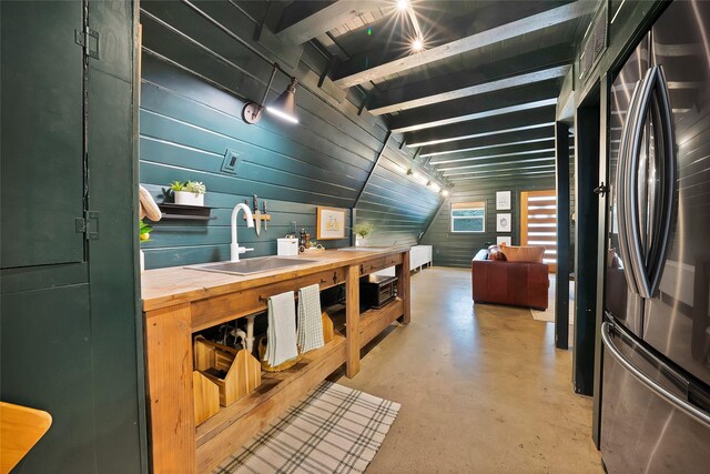 120 Lakeway Ln, Gun Barrel City, TX 75156 - kitchen with smart refrigerator, wood counters, concrete floors, beam ceiling, and wood walls