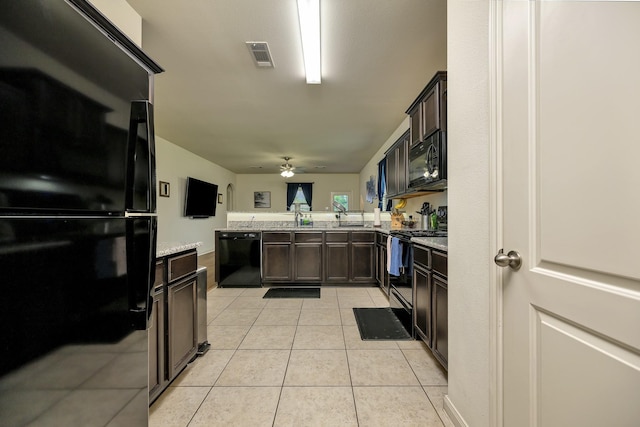 5921 Obsidian Creek Dr, Fort Worth, TX 76179 - kitchen featuring black appliances, a peninsula, dark brown cabinetry, light tile patterned flooring, and ceiling fan