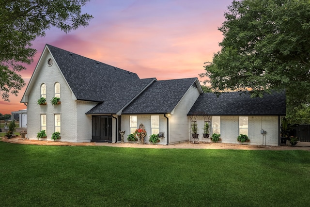 9867 Dripping Springs Rd, Denison, TX 75021 - view of front facade with a shingled roof, brick siding, and a lawn