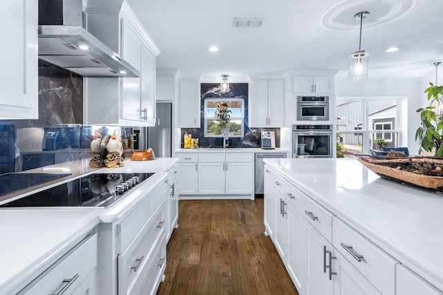 9867 Dripping Springs Rd, Denison, TX 75021 - kitchen with wall chimney range hood, appliances with stainless steel finishes, recessed lighting, backsplash, and white cabinets