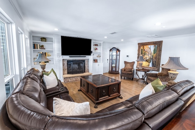 9867 Dripping Springs Rd, Denison, TX 75021 - living area featuring crown molding, wood finished floors, a fireplace, recessed lighting, and built in shelves