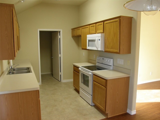 5905 Pacers Ln, Fort Worth, TX 76179 - kitchen with white appliances, light countertops, brown cabinetry, lofted ceiling, and light floors