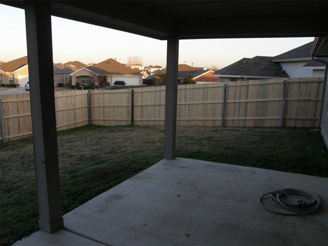 5905 Pacers Ln, Fort Worth, TX 76179 - yard at dusk featuring a patio area, a fenced backyard, and a residential view